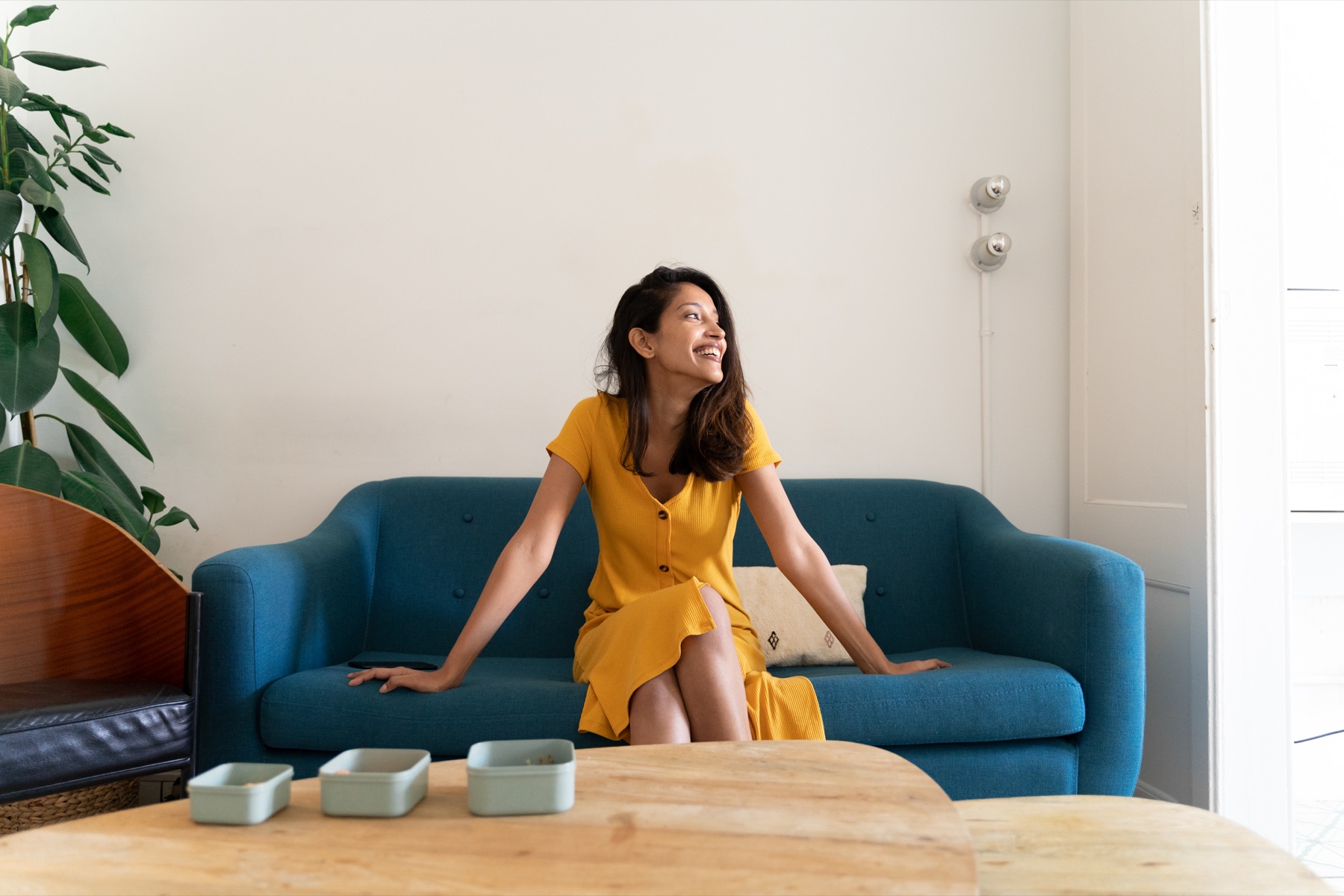 A client relaxing at home on her sofa